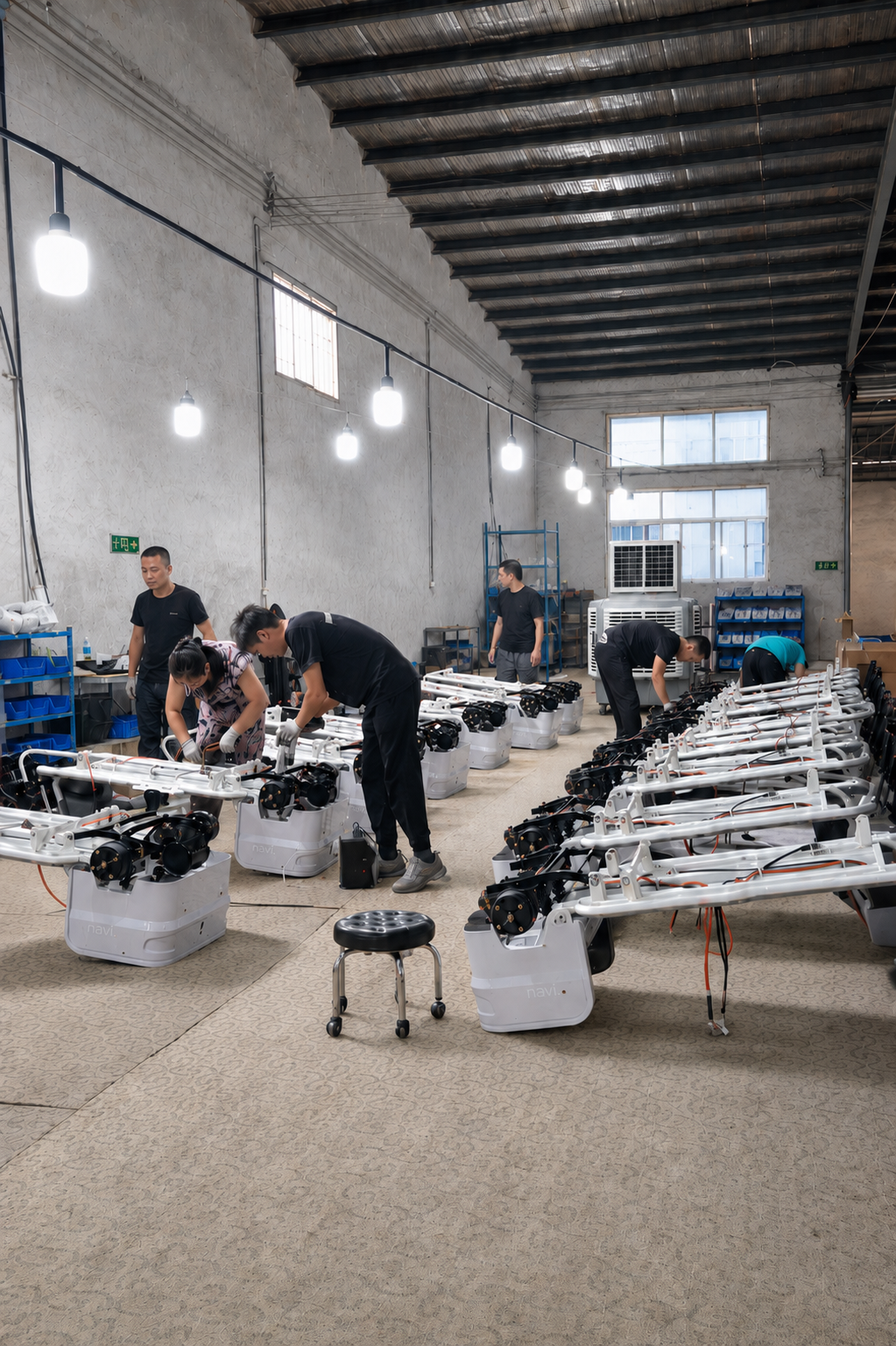 NAVERO workers assembling electric tricycles and electrical systems